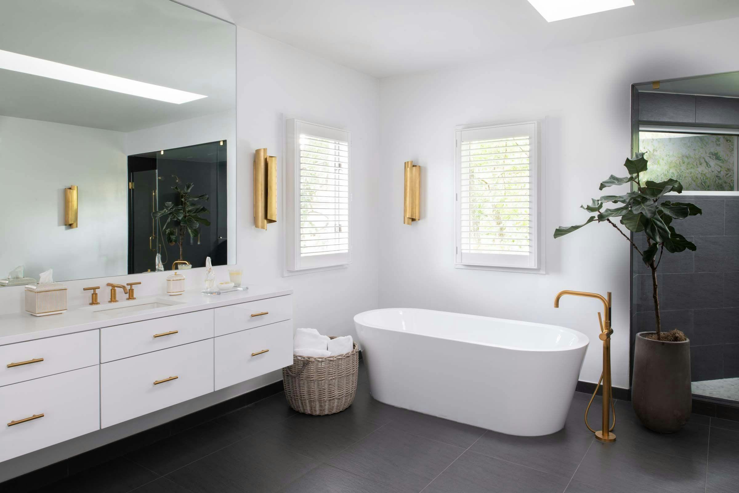 Oaklyn master bathroom with clawfoot tub and golden accents
