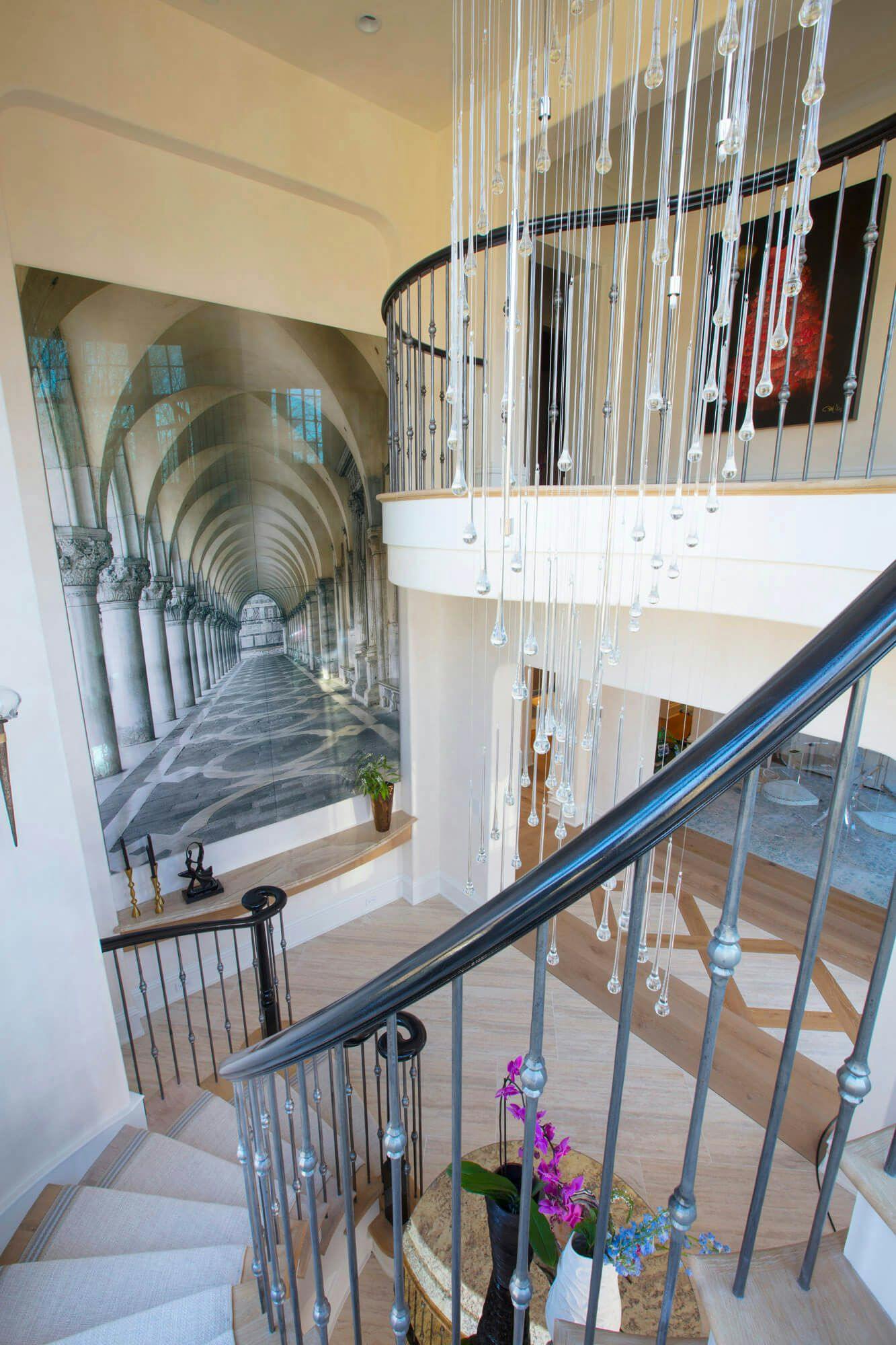 Spiral stair case look from the top with a large canvas paitning