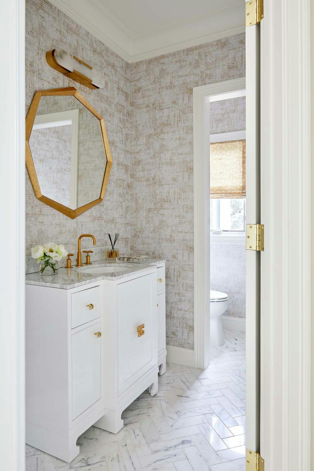 bathroom with white cabinets and golden accents