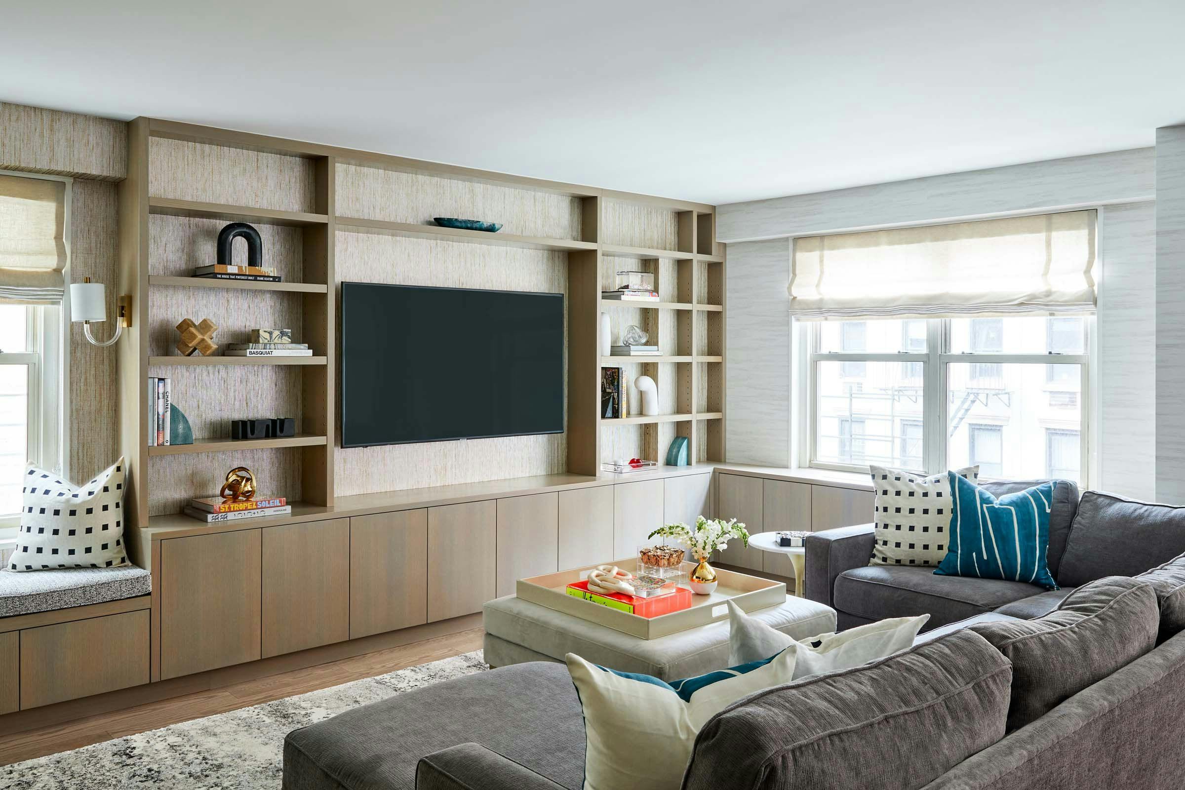living room with mounted tv and shelving