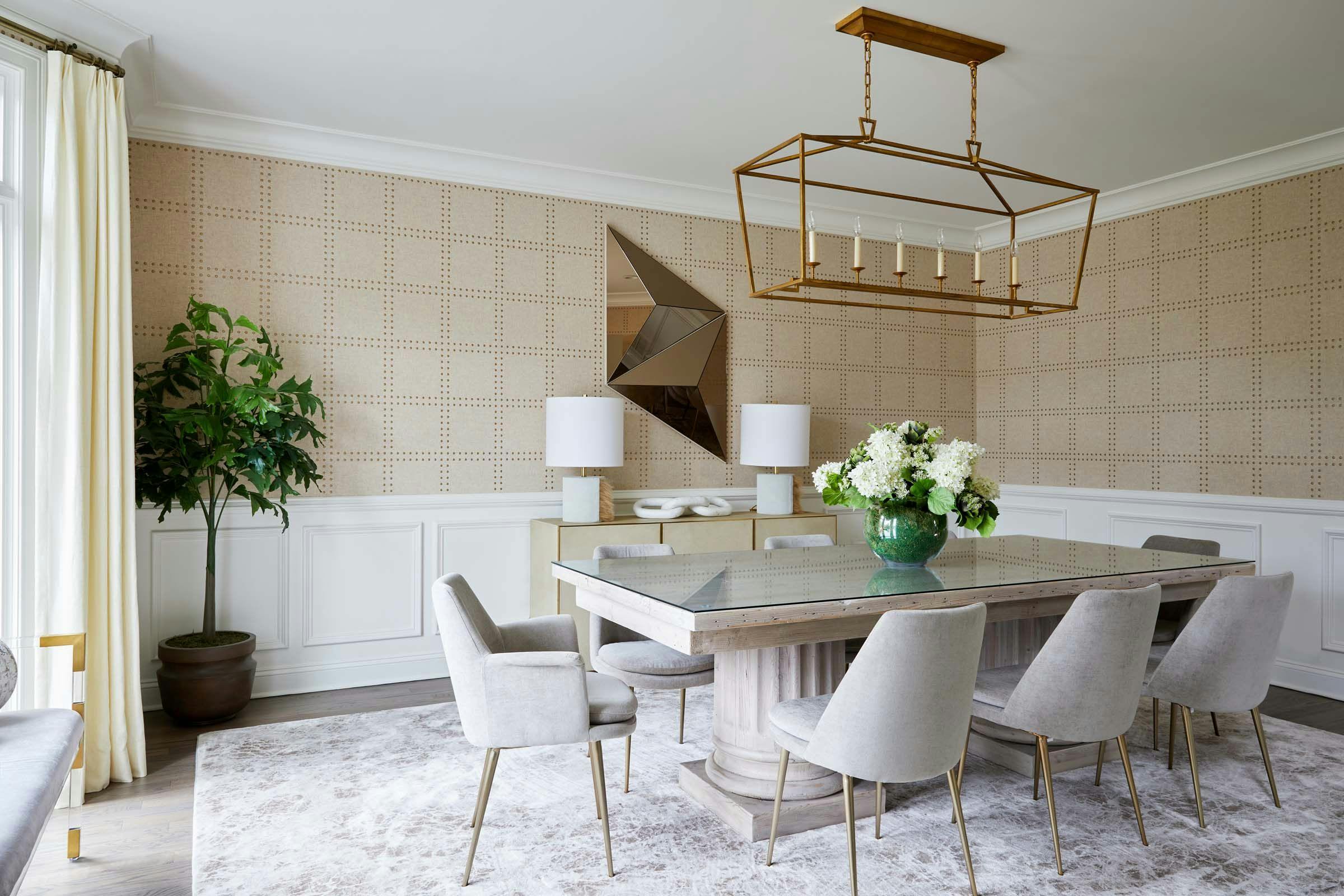 dining room with rectangular dining table with gray chairs and golden accents