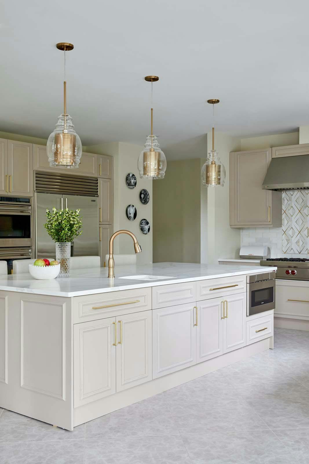 kitchen with off-white cabinets and golden accents