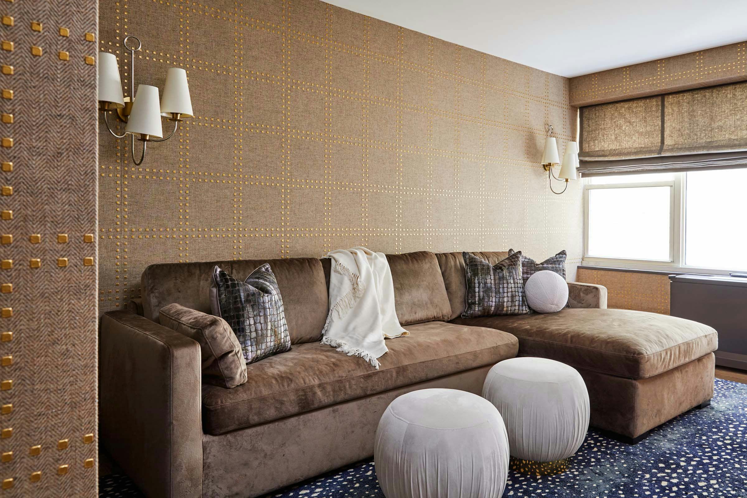 brown couch against a brown wall with accents and gray ottomans