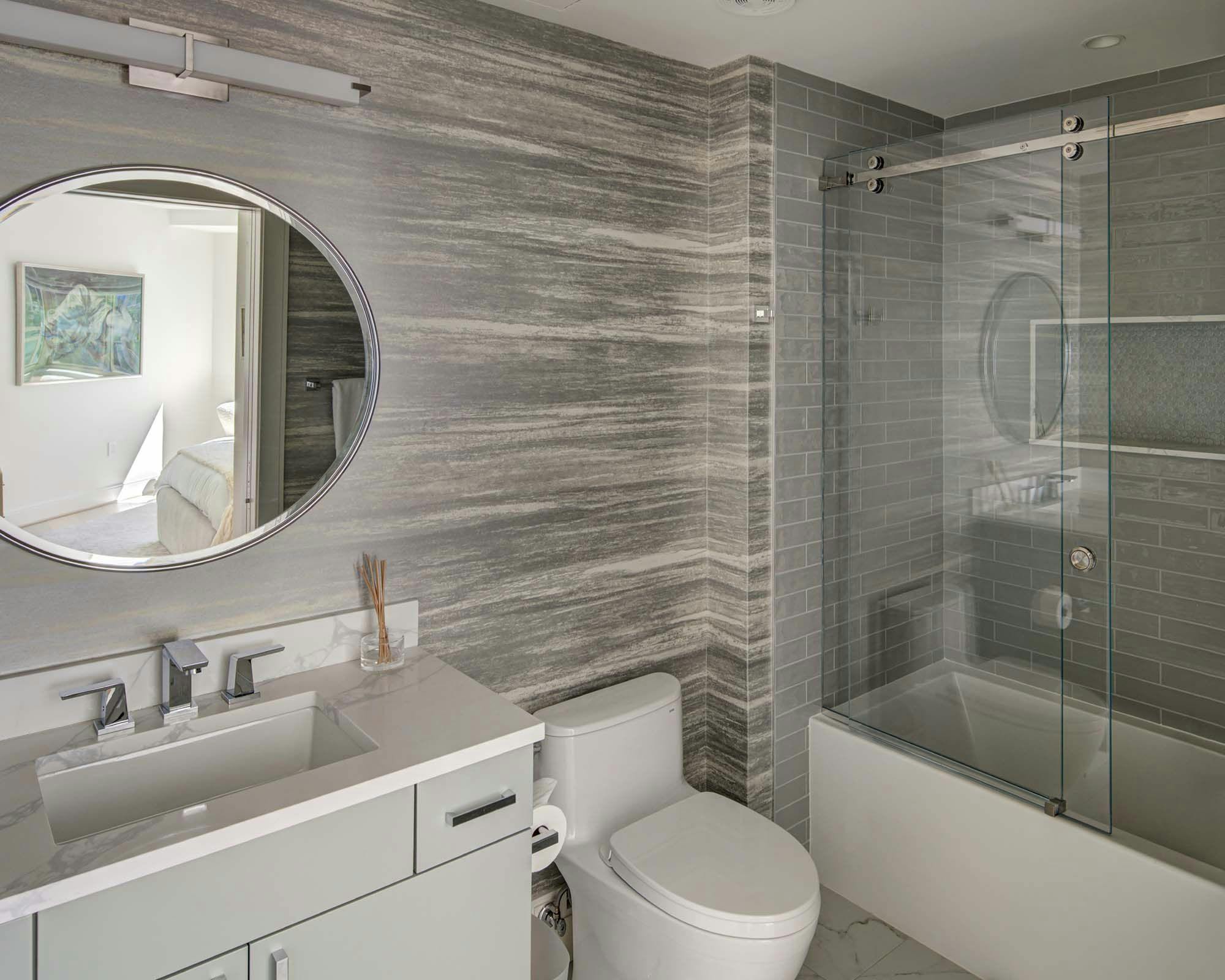 bathroom with single sink and tub shower in light gray colors