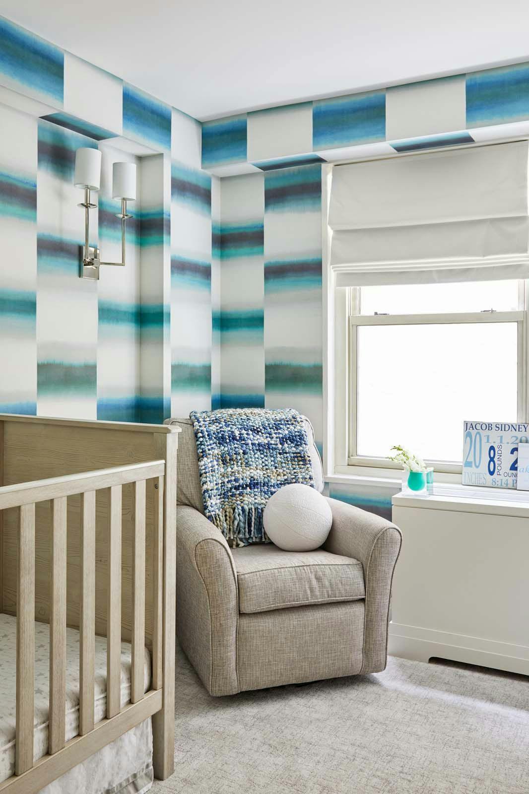baby's room with ombre style wall treatment and gray couch