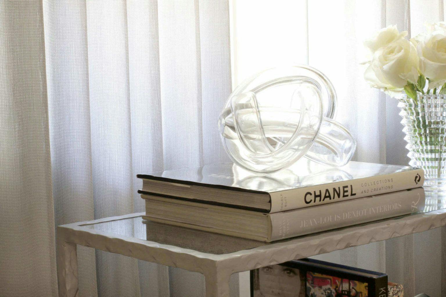 crossover table with books and decorative glass sculpure