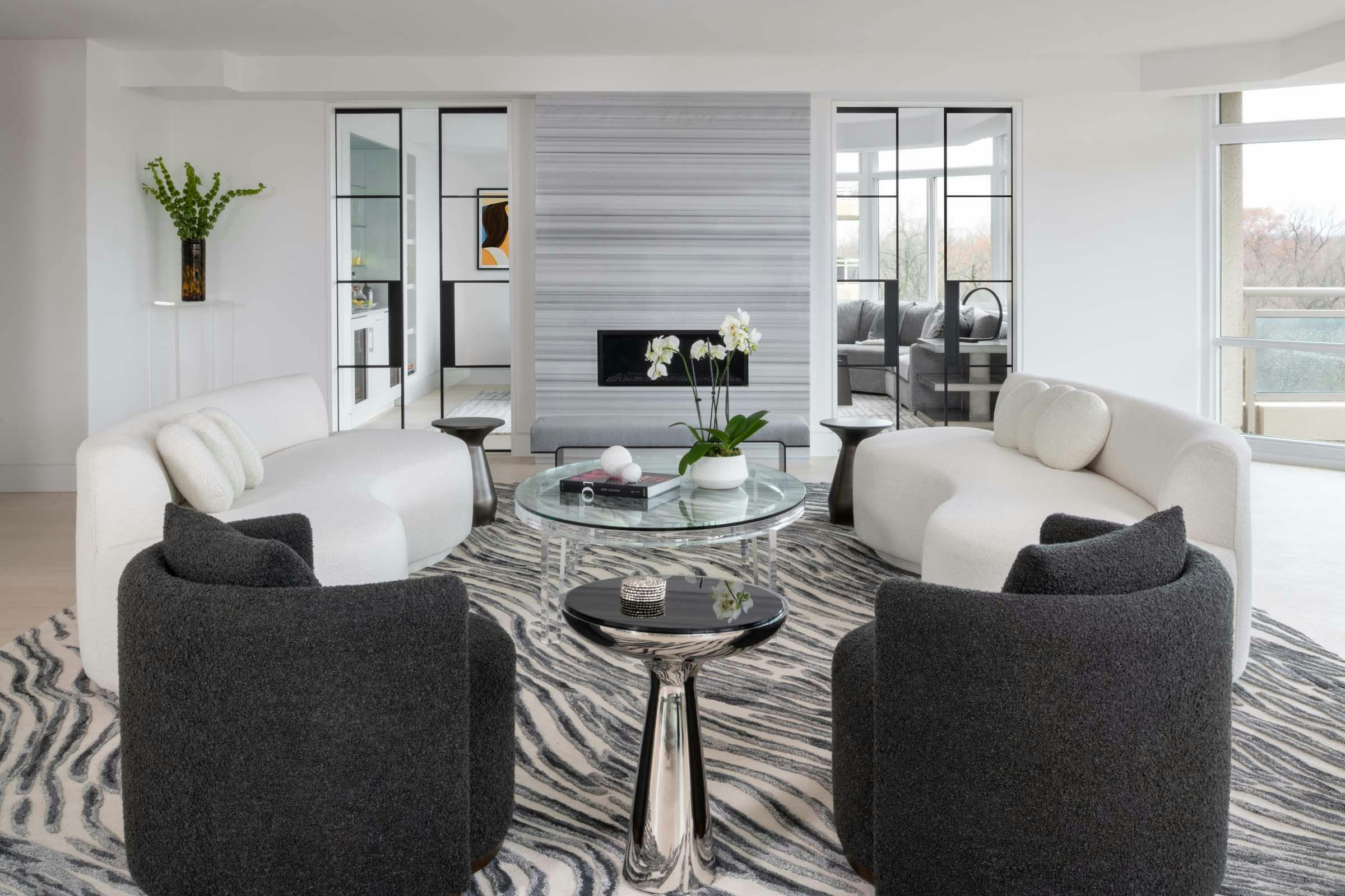living room with black and white couches and a fireplace